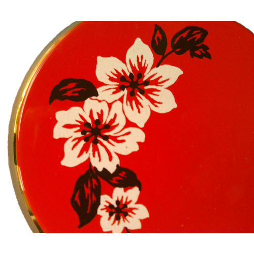 A Vintage Stratton Orange and White Flower Compact